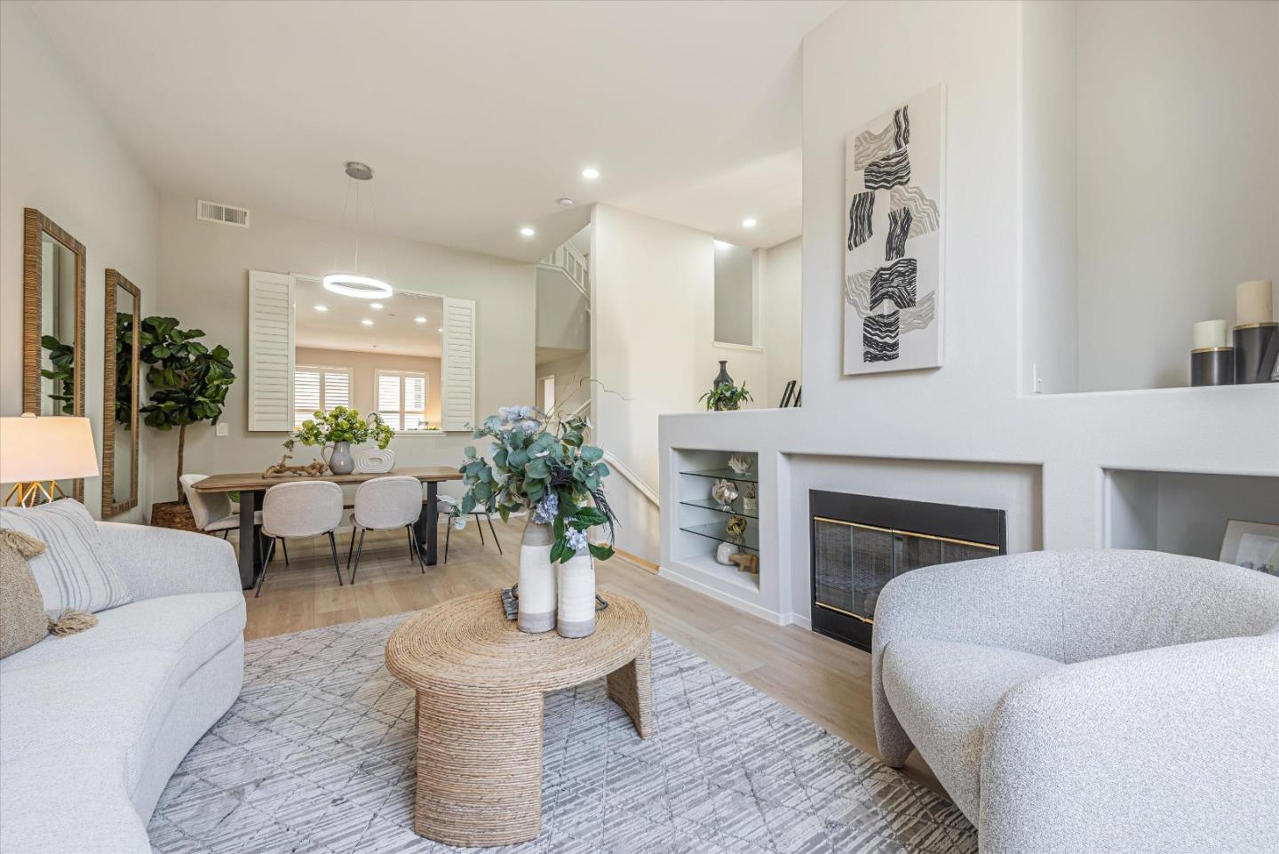 The bright living room of a Foster City townhouse with a fireplace.