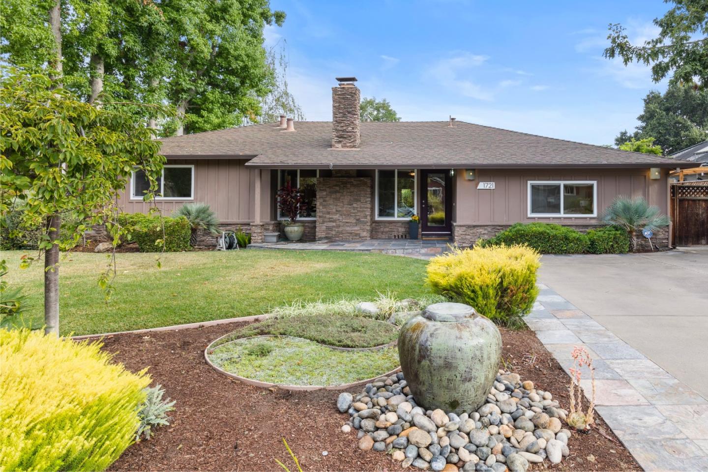 A side-on shot of a tan single-story home.