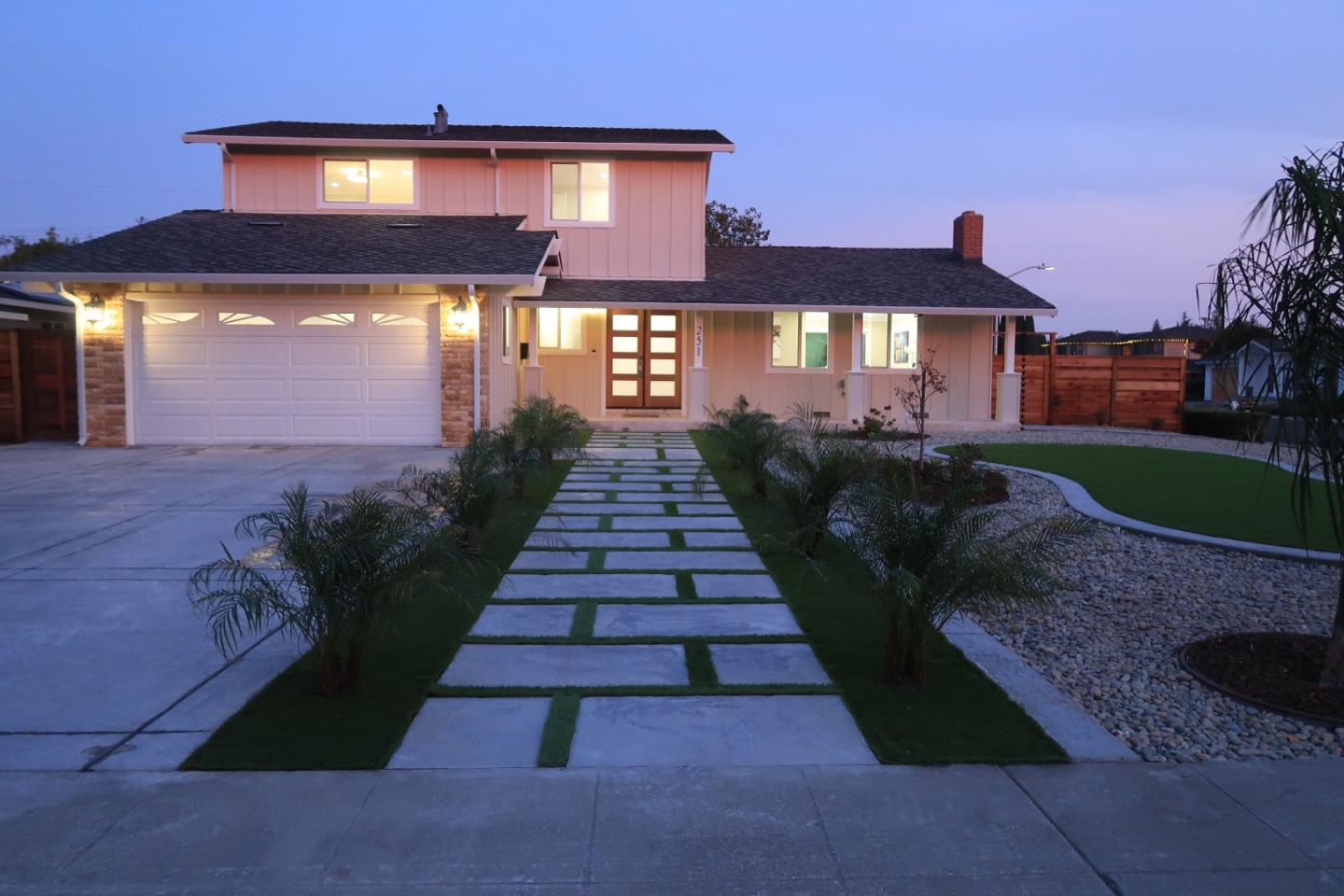 A side-on shot of a tan single-story home.