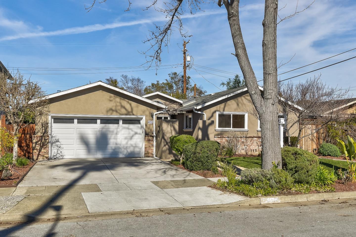 A tan single-story home.