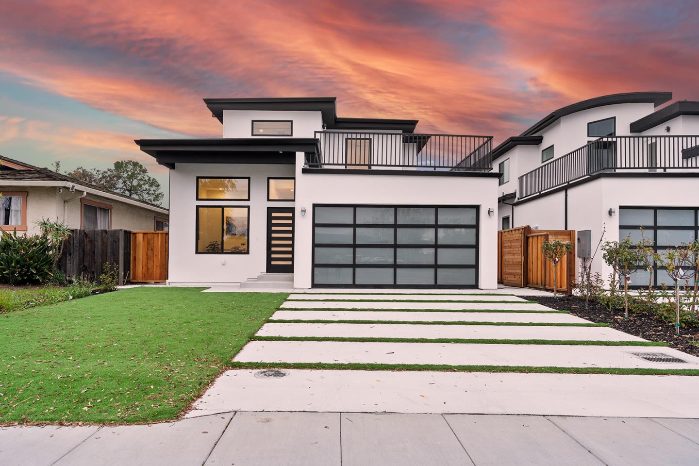 A white two-story home with black trim.